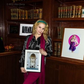 Art Walk, Cash Mob Slated Saturday Model Selina Kyle shows photos at a previous Art Walk